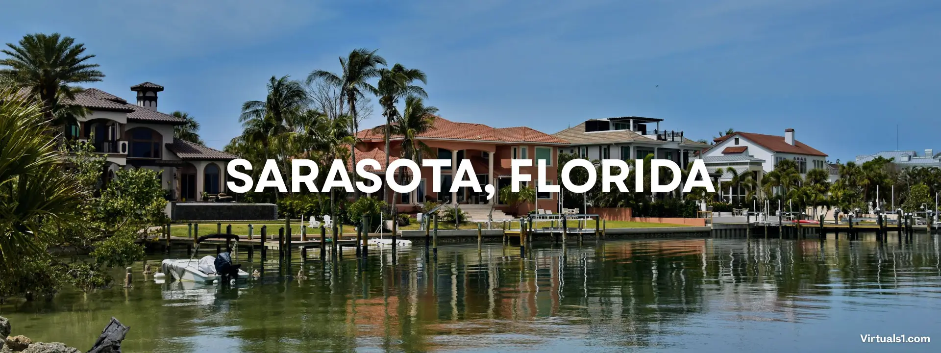 Elegant waterfront home in Sarasota, FL, with a pristine pool area overlooking a bay, professionally captured for real estate.